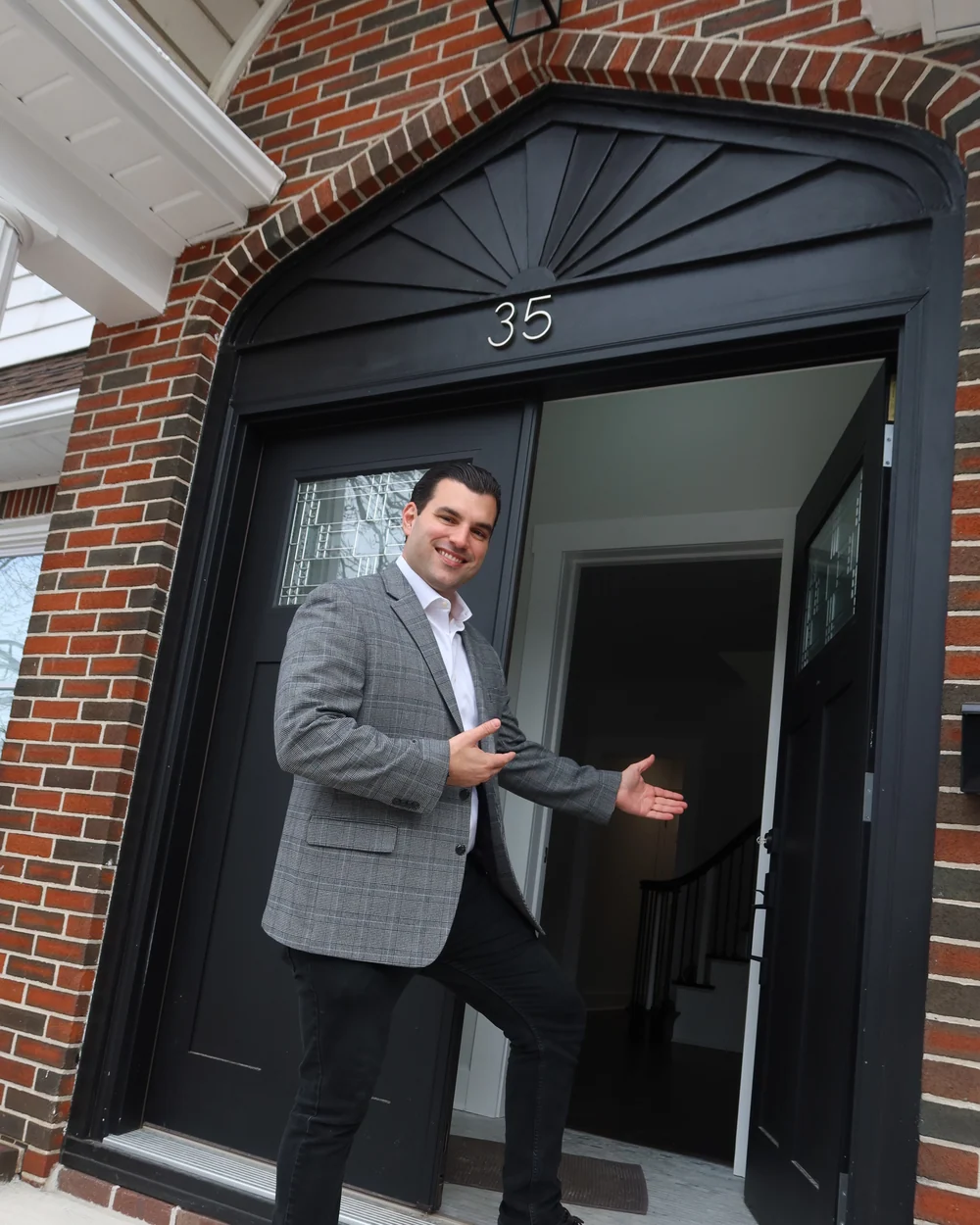 Joseph Ranola opening the door of a Staten Island home he sold